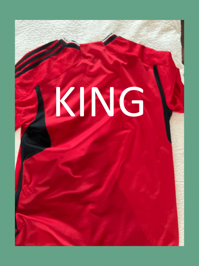 Red custom football jersey with a personalized name printed in bold white text on the back.