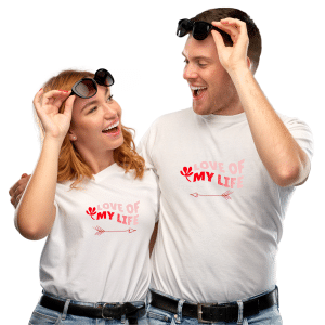 A happy couple wearing custom Valentine’s Day T-shirts with romantic designs, celebrating their love with matching outfits.